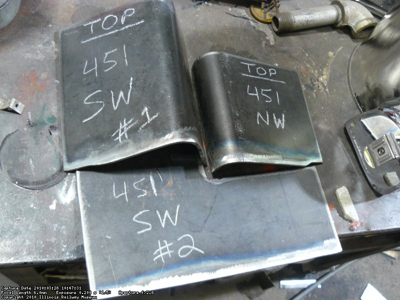 The patches cut out, shaped, and ready for sandblasting and priming on the inside, then they can be welded onto the car.