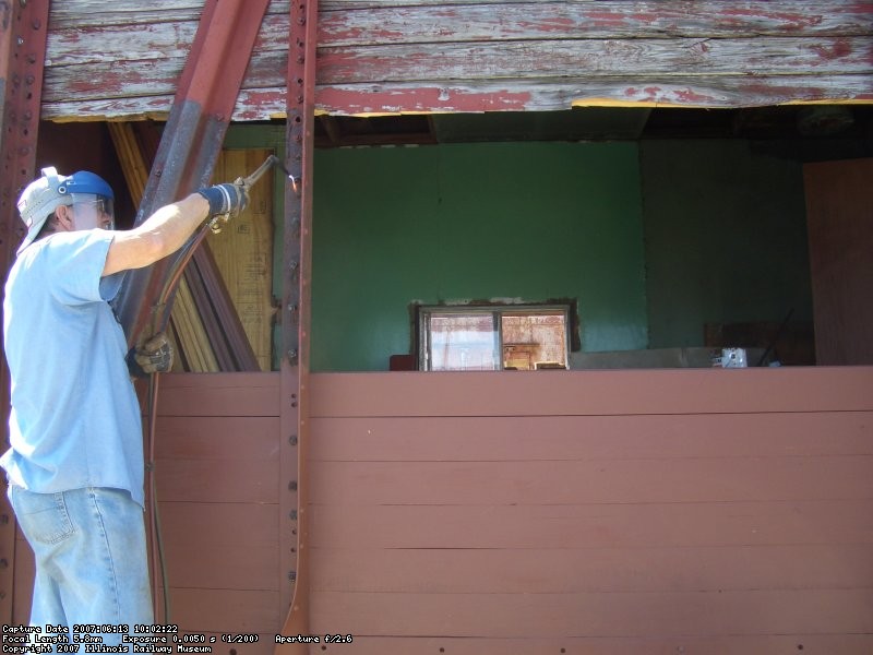 06.13.07 - JOHN FAULHABER IS HEATING THE TIMBER BOLTS TO IMPROVE THE EASE OF REMOVAL AND ALLOW FOR THEIR REUSE.