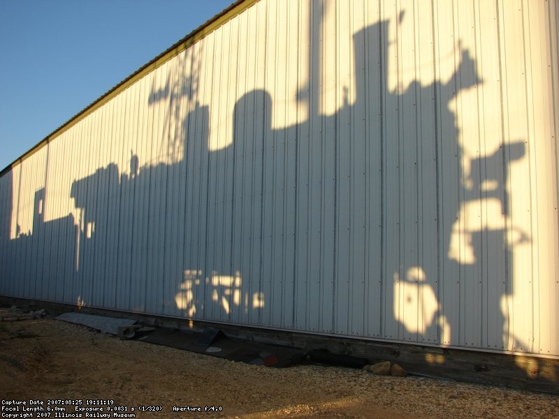 The locomotive casts a shadow on barn 9 as prep for the drop is completed in the late summer light