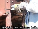NEIL SCHWINBECK IS CUTTING THE DAMAGED VERTICAL HANDOLD SUPPORT.