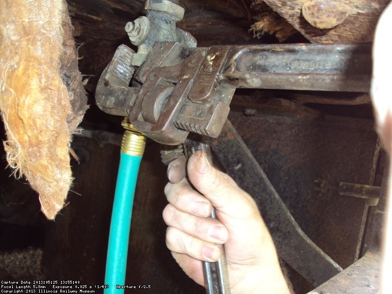 Close-up of Chuck carefully opening the valve to drain the heating system fluid