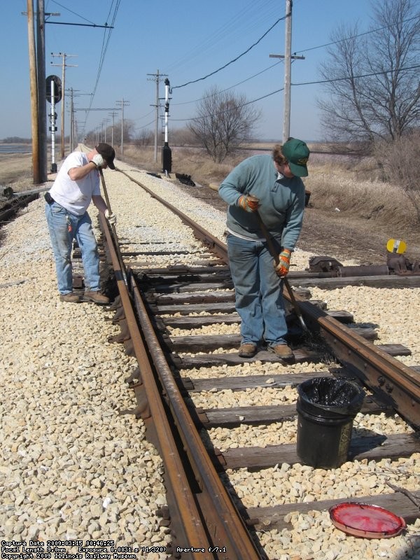 Frank and Steve sweeping and greasing the spring switch at the west end of Johnson Siding