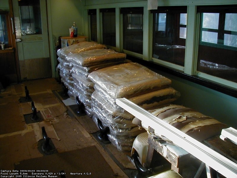 Feb 19, 2003, seats stripped of their upholstery are stacked in the car waiting for work.