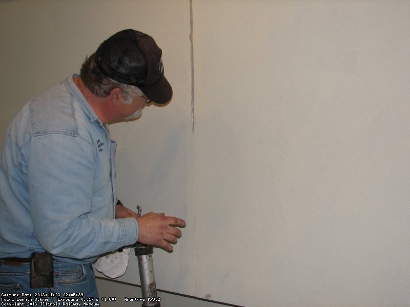 Mike Baksic caulking seams in the 2nd Exhibit Car November 3, 2013