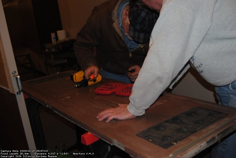 Mike and Kevin removing metal from door