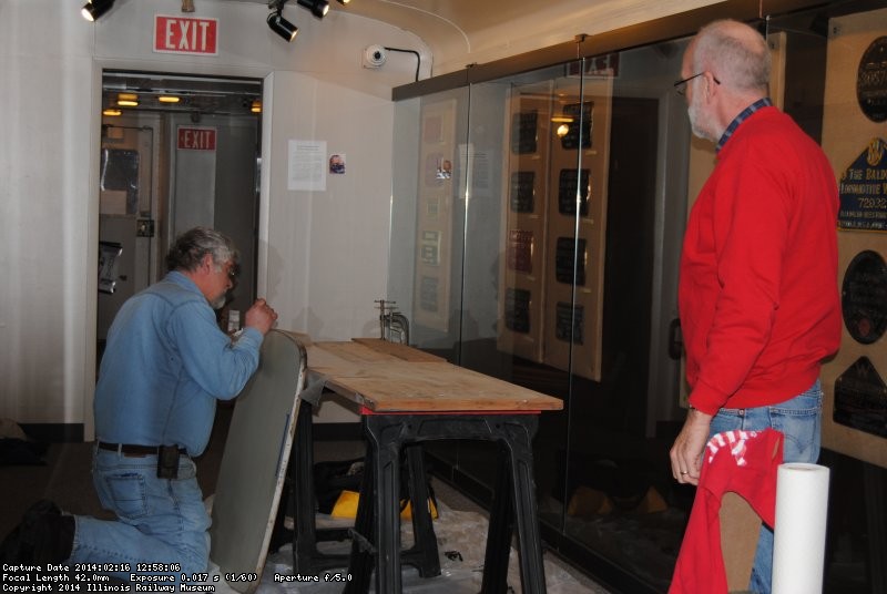 Mike applies epoxy to a Birmingham table while Jon Habegger looks on 2/16/14