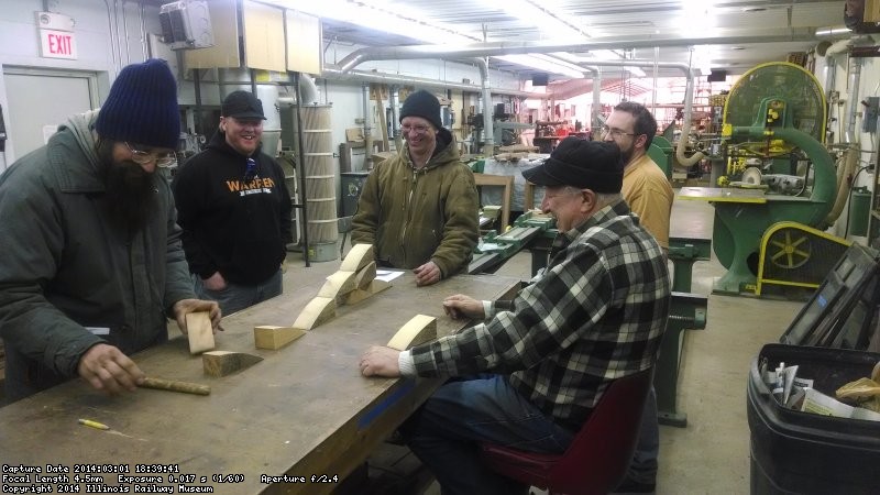 Easily amused by wood scrap, a crowd gathers around Nick