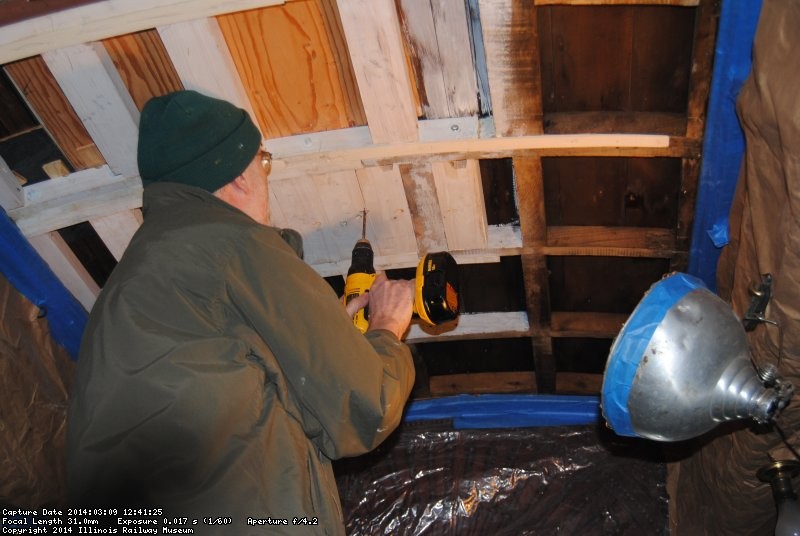 Buzz drilling a pilot hole through the Ely roof