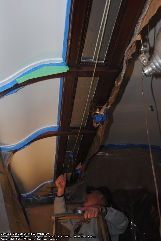 Kevin Kriebs applying duct tape to the Ely dining room ceiling