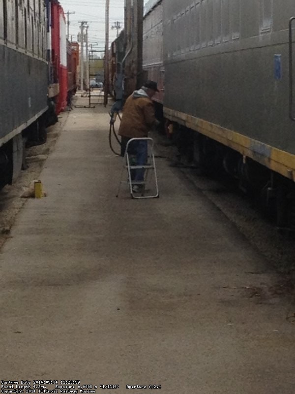 Kevin Kriebs removing adhesive on the 1st Exhibit Car - image by Michael McCraren