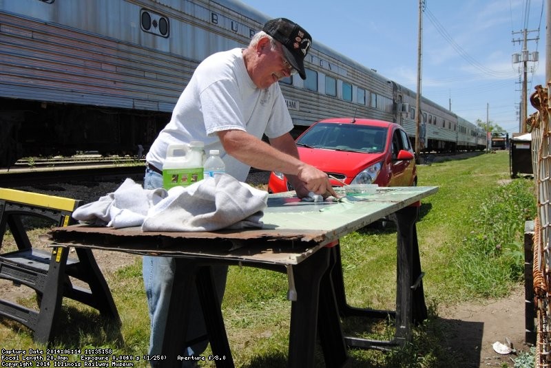 Kevin Kriebs stripping paint from a door to be used in the Birmingham - Photo by Shelly Vanderschaegen