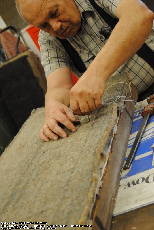 John McKelvey sewing upholstery padding layers together - Photo by Shelly Vanderschaegen