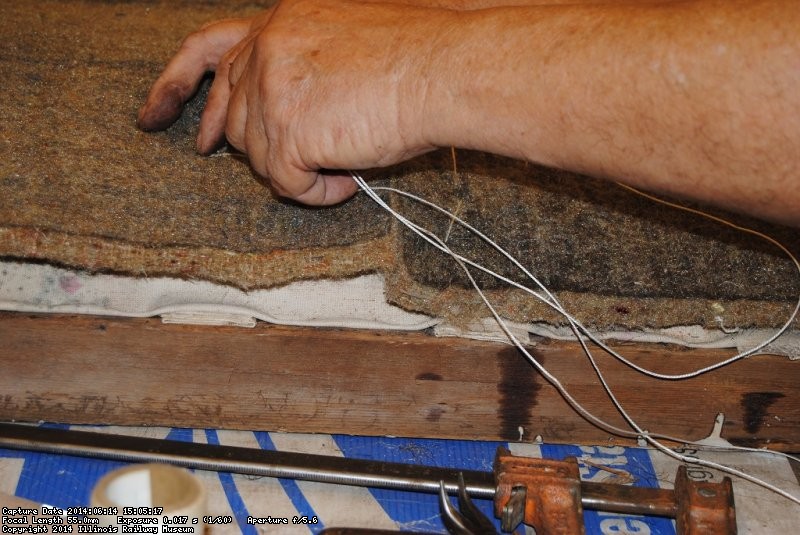 John working on layers of seat material for a Henrietta coach seat - Photo by Shelly Vanderschaegen