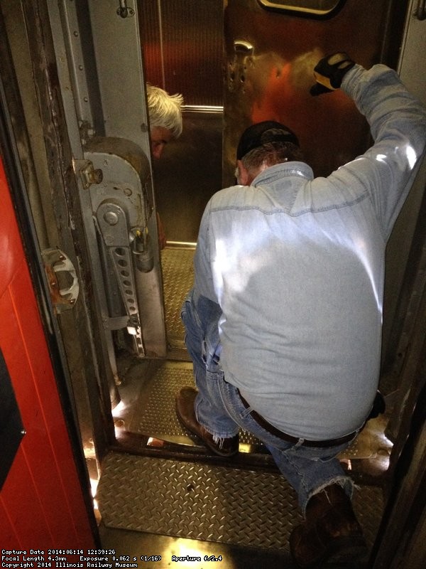 Mark G. and Michael B. kneeling down to work on the kitchen end door - Photo by Michael McCraren