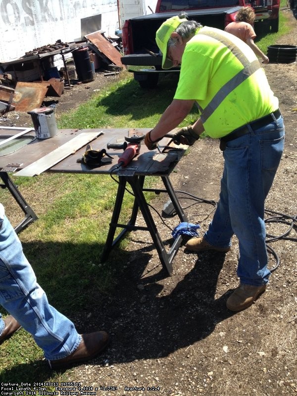 Mark Gellman removes rusted bottom of door - Photo by Michael McCraren