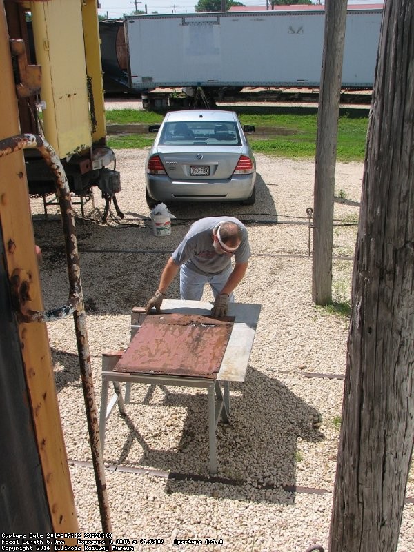 Chuck uses the old door face as a template for the replacement cover - Photo by Pauline Trabert