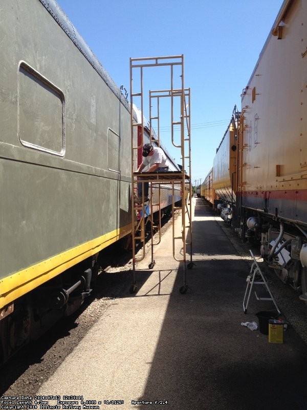 Kevin Kriebs removing adhesive on the 1st Exhibit Car - Photo by Michael McCraren