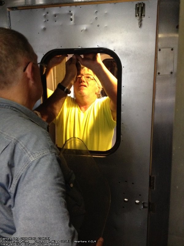 Ray and Mark set the rubber to hold the window - Photo by Michael McCraren