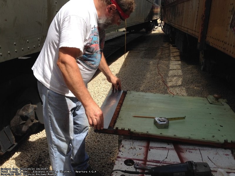 Chuck fitting the patch on the panel bottom - Photo by Warren Newhauser