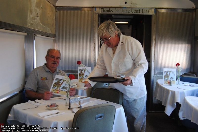 Mark Gellman practices his waiter skills on Kevin Kriebs - Photo by Shelly Vanderschaegen