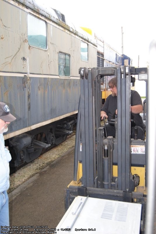 Jeff Calendine at the fork lift controls for AC removal - Photo by Shelly Vanderschaegen