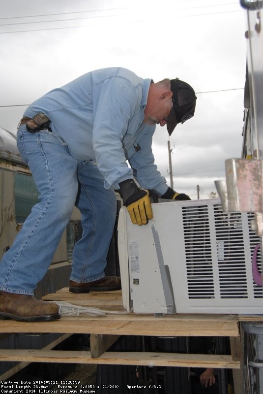 Michael Baksic pulling out one of the AC units - Photo by Shelly Vanderschaegen