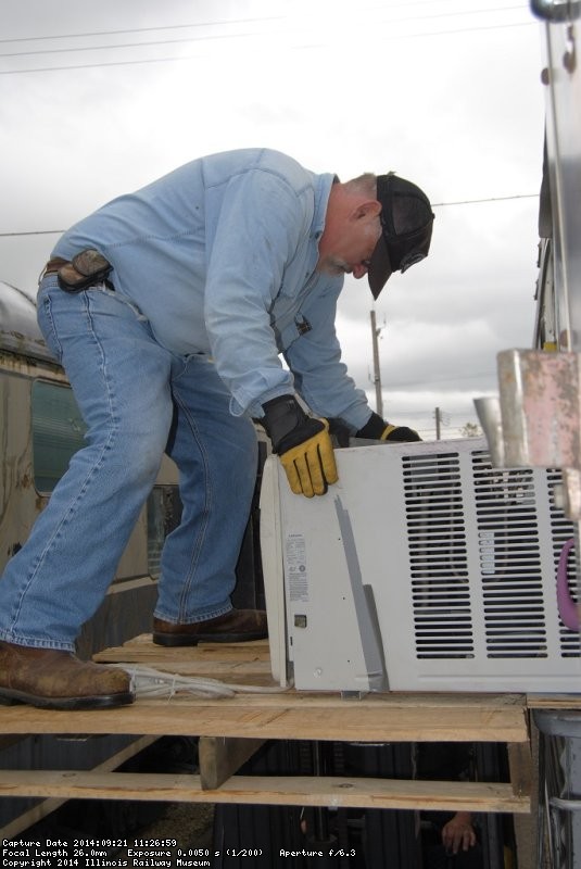 Michael Baksic pulling out one of the AC units - Photo by Shelly Vanderschaegen