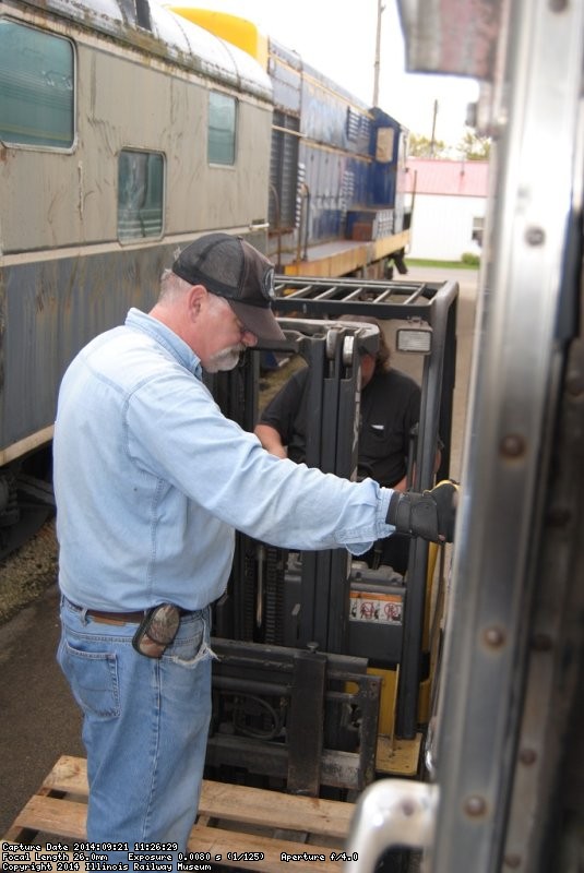 Michael Baksic stands on the fork lift platform - Photo by Shelly Vanderschaegen