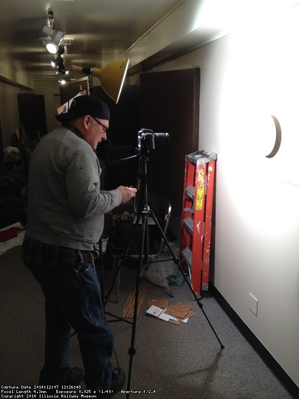 Jim Windmeier took pictures of the china for later use - Photo by Michael McCraren