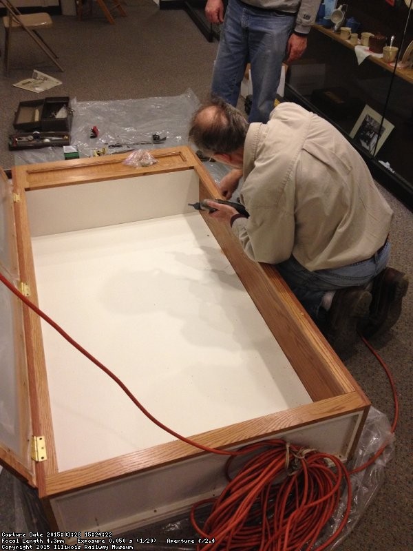 Buzz working on the cabinet hardware - Photo by Michael McCraren