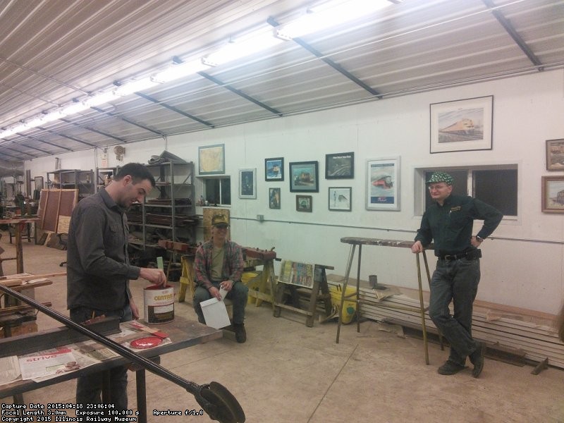 Frank, Joel, and an unidentified person discuss the new training machine - Photo by Brian LaKemper