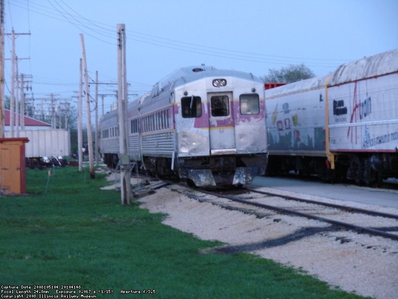 as the suns sets, the set, headed up by its new end car, slides into its siding