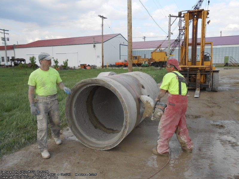 Concrete sawing contractor cutting pipe to size.