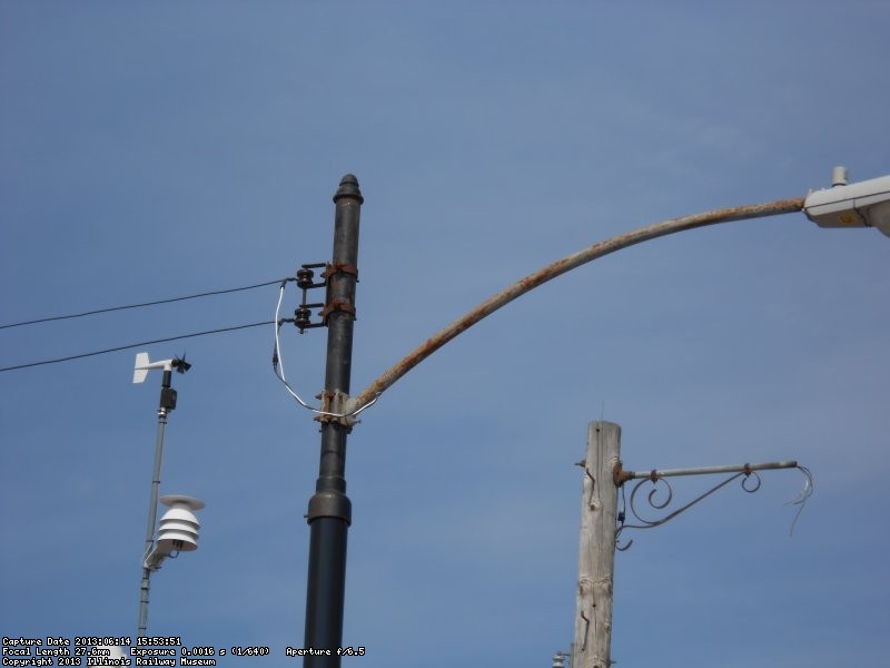 Newly installed steel pole fitted with 1950's era Chicago style pole extension and 8' street light arm.