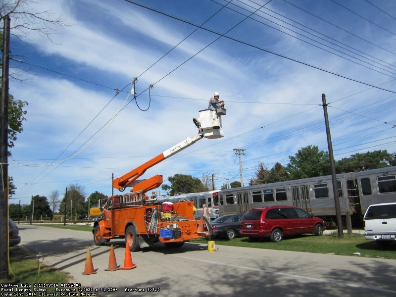 Notice the shorting and grounding cables installed on the old trolley bus wires for safety.