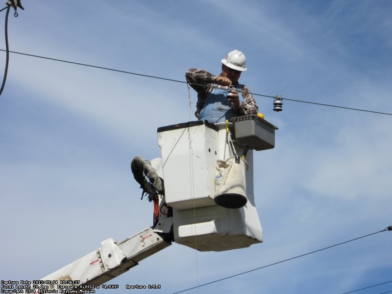 Installing hanger insulators for North bound trolley busses on Railroad Avenue.