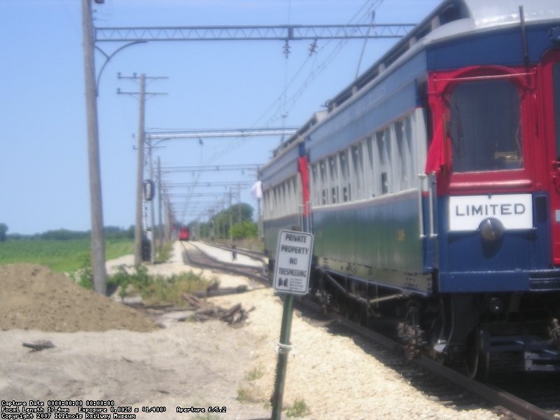 As train 308 departs, the 2nd section, car 431, approaches from the west.