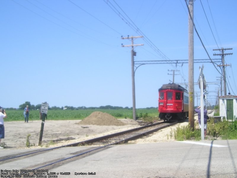 Train 431 whistles for the crossing as it approaches Forest Park.