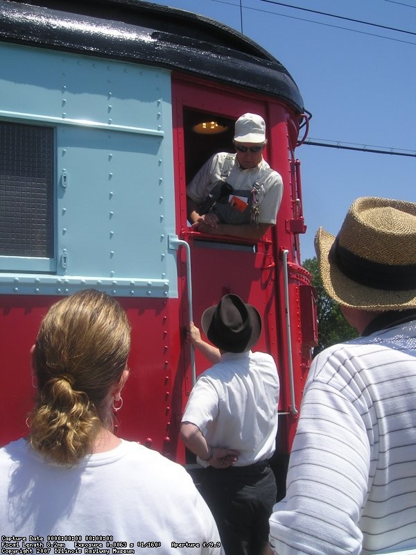 Before the train could depart, a man in a hat (Frank Hicks) speaks with motorman Jeff Obarek.