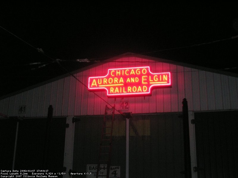 The restored neon CA&E sign on the front of barn 4 is lit for the first time