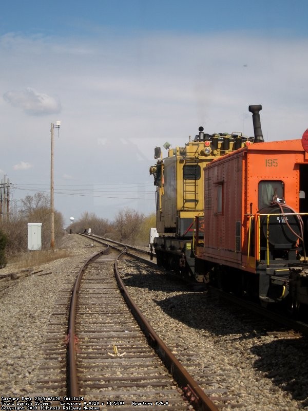 EJ&E Crane 245 with caboose travel west...