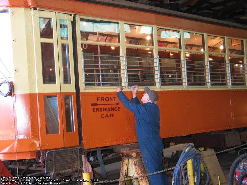 Jim Heinlein finishes attaching window grills.