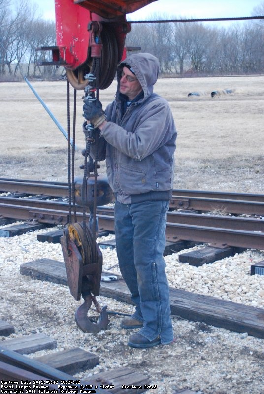 Tom finishes putting the four part hook back on.