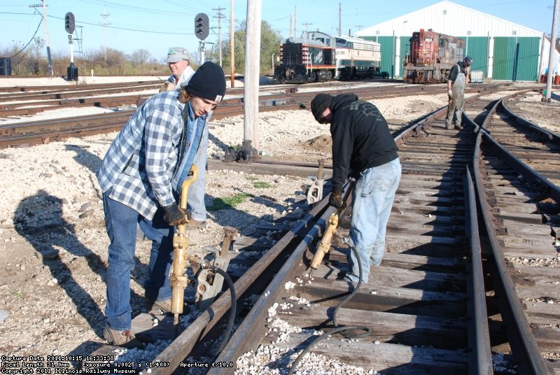 After lifting comes gun tamping, as the inspector checks the work