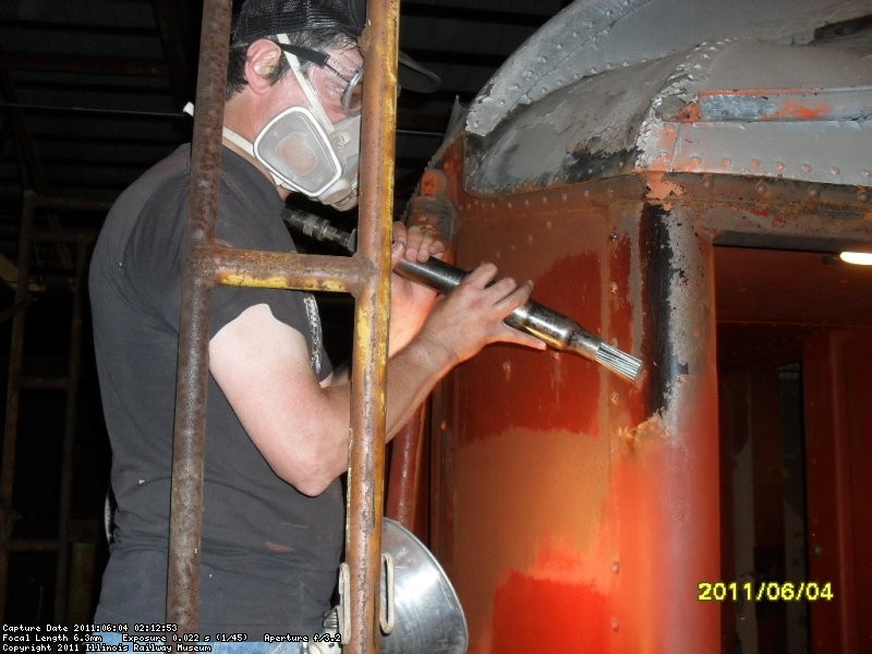 Mark Hoffman needlechipping area on John Mcloughlin. He will then prime  the area before Roger begins to drill  holes for Marker lt bracket June 2011
