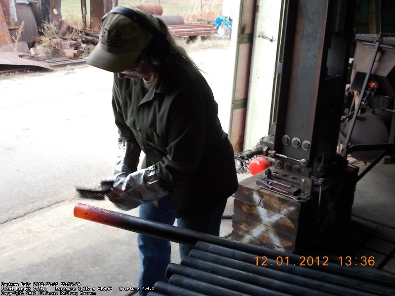 Yes, that's one of our lady volunteers cleaning the tube after it has been heated.  12-1-2012