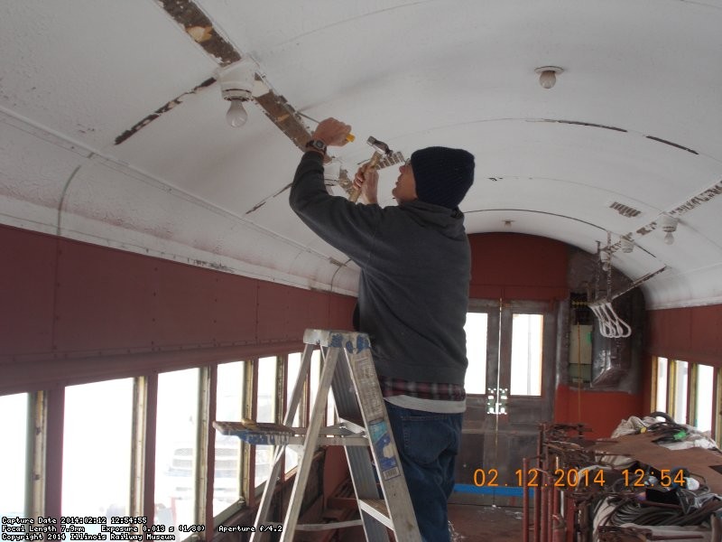  Lincoln's birthday..  Here's Gary scraping paint of ceiling in the cold We don't have a warm area but the little crew keeps on working     DSCN0727