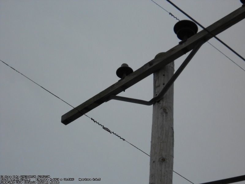 Close up of insulator blasted by lighting.  Primary phase wire is floating under the arm. Yes, it's still hot.