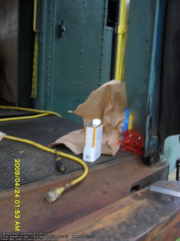 April 2009  Roger painting and reinstalling sissors gate in vestibule of CNW 7700.  Mike, Shelly and Ray reinstalled baggage rack and repaired ceiling leak 