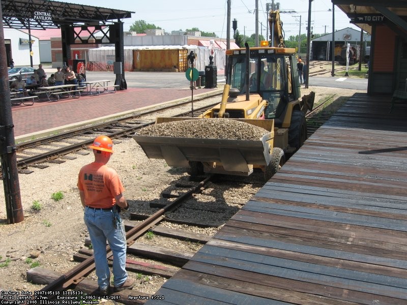 Frank guiding backhoe with ballast